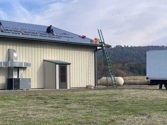 Panels sitting on the roof doing nothing because they're not connected to anything