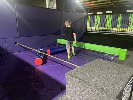 Tight rope and balance beam with foam pugil sticks to fight with