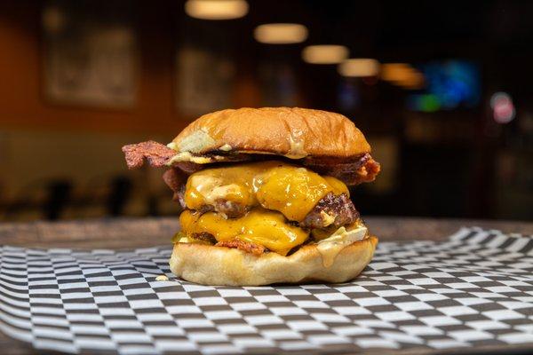 The Classic - Two American Wagyu patties, 2 slices of cheddar cheese, bacon, diced onions, pickles, and Foxtrot sauce.