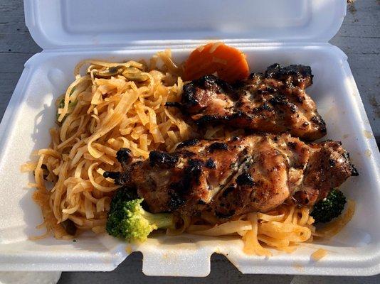 Grilled chicken kabobs over pad Thai