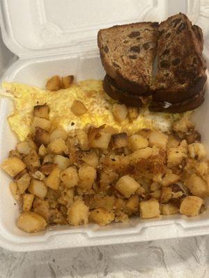 Egg and cheese omelette with home fries and raisin toast