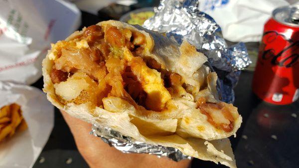 Interior of vegan breakfast burrito ($12). Not good. Starchy, bland mess of beans, Just Egg & too much Violife mozzarella.