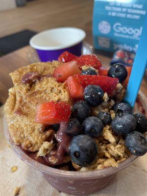 the beach bowl with strawberries and blueberries on top and peanut butter