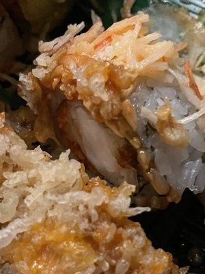 Imitation crab on angry roll that is supposed to be king crab