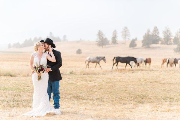 Bride and Groom portrait with horses in the background