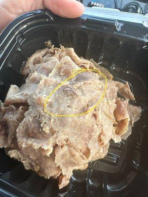 Roast beef with what appears to be a pubic hair on top