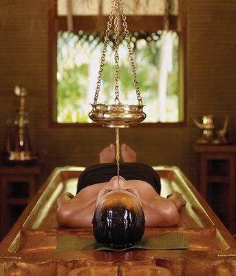 Shirodhara- A deeply relaxing treatment involving pouring a stream of warm oil over the forehead for relaxation and relieving mental stress.