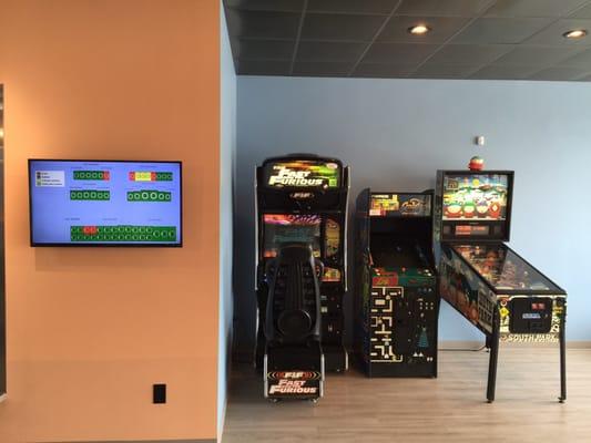 A mini arcade and a monitor that tells you which machines are in use, almost finished and which are available.