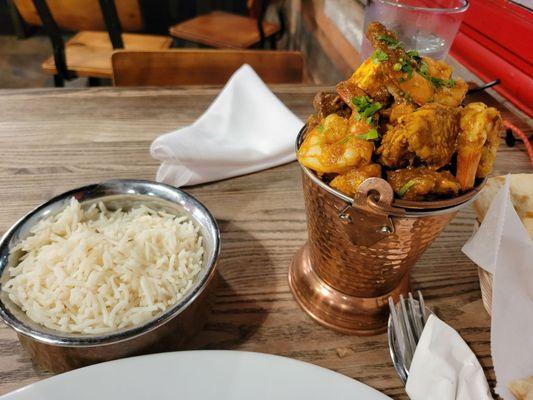 Presentations for the House Specialty: Mixed Balti with lamb, chicken, shrimp, and tofu. $17.95