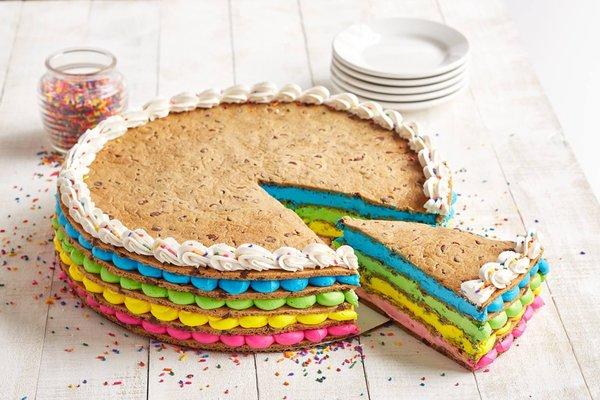 Home of the original cookie cake!  This one is our Unicorn cake which is multiple cakes layered with icing in between each cake!