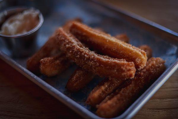 Churros with chocolate sauce.