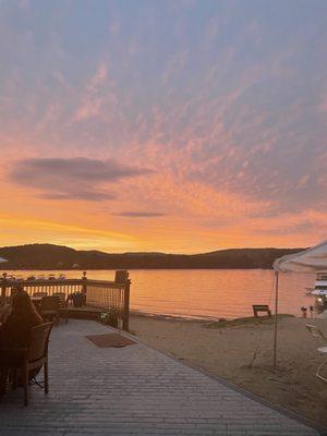 Outdoor patio view of lake at sunset