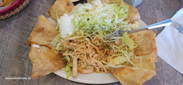 Taco salad with chicken. Menu does not list onions, tomatoes and peppers but it came all cooked together. They said ita precooked this way.