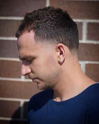 High skin taper. With a textured top. Done by Ethan available from any barber in the studio.