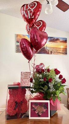 Two dozen red roses with balloons, and a flower bear