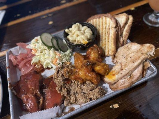 BBQ platter: Mac & cheese, toast, smoked turkey, Thai chili chicken wings, vinegar base pulled pork, and bbq brisket, with extras