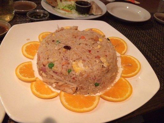 Thai Fried Rice with chicken and a beautiful sun of orange slices.