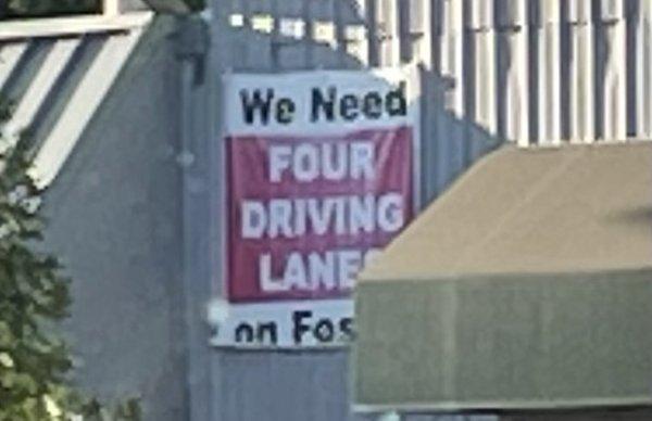 The Gun Room supports four driving lanes on Foster.