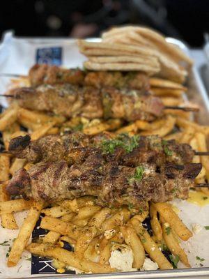 A pair of chicken souvlakia and a pair of pork with some Greek fries. Super good and fresh food.