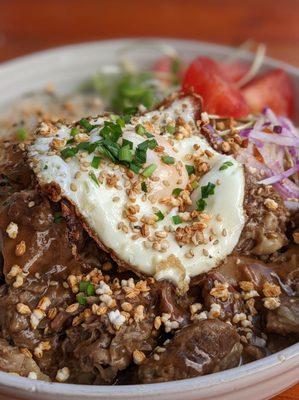 Braised beef loco moco with papaya salad, sunflower micro greens, crispy rice, egg