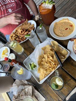 Catfish, okra, onion rings, queso and chips, bacon cheese burger and fries, Dos Equis beer.