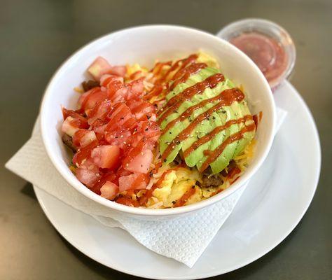 Brekkie bowl with sausage, avocado and sriracha.