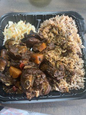 Stew chicken with rice and gravy.