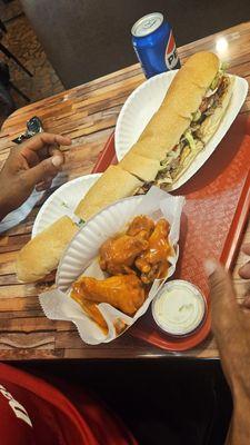 16 inch Philly Steak & Cheese Sub w/ hot wings & fries (not pictured, but they were PERFECT)