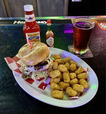 Smash burger with tots and a cold Crawford Bock.