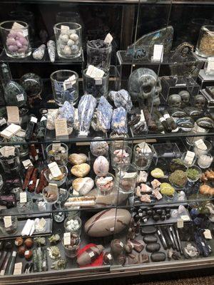 One case of many displaying crystals, stones and some of the products from these mediums.