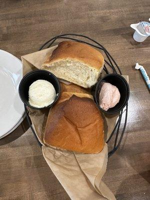 Fresh bread with regular butter and strawberry butter.