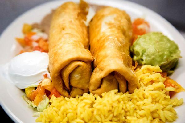 Las Chimichangas' Two Deep Fried Flour Tortillas Stuffed with Chicken or Beef, with Guacamole, Sour Cream, Rice and Refried Beans