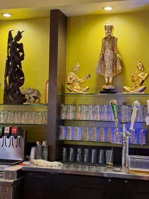 Intricate Thai statuettes inside restaurant