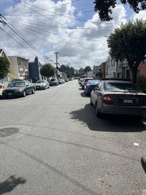 Street parking, fields at the end of the street.