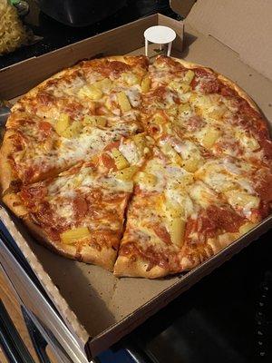 Traditional pizza with red sauce, pepperoni and pineapple.