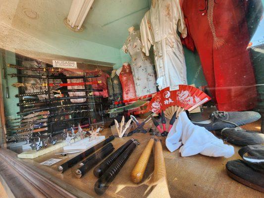 Front Of Store: Cultural Swords, Fans, Historical Clothings.