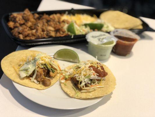 Chicken Street Tacos-generous grilled chicken, shredded cabbage, shredded cheese blend, limes, 12 tortillas, salsa & crema