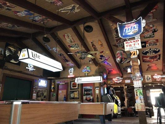 Pool tables, juke box shot from open air bar area.