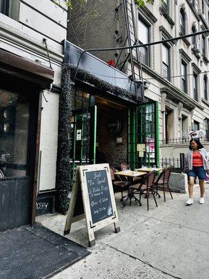 Outside tables with window wall open to street