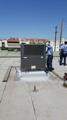 Installing a York package unit on the roof of a local business.