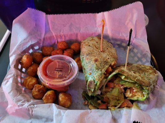 Buffalo chicken wrap with spinach tortilla and sweet potato tots