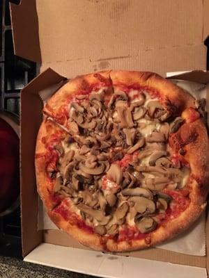 Small mushroom pizza with extra mushrooms .