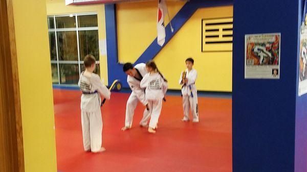 Our daughter learning a new kick with Master JH Kim!