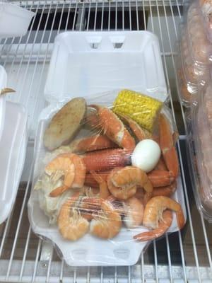 Crab legs, shrimp, potato, corn and an egg