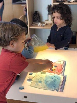 My son playing with a light table sensory activity (pre-covid).