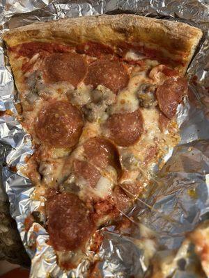 Pepperoni & sausage pizza slice