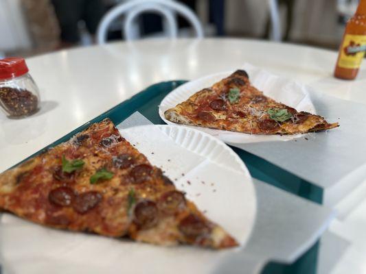 Pepperoni topped with fresh basil, Parmesan, and red pepper flakes