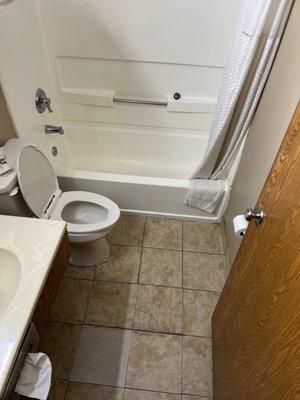 Broken tiles and black bath tub floor