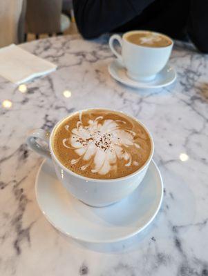 Cappuccino and Irish cream mocha. Cute milk foam art!!