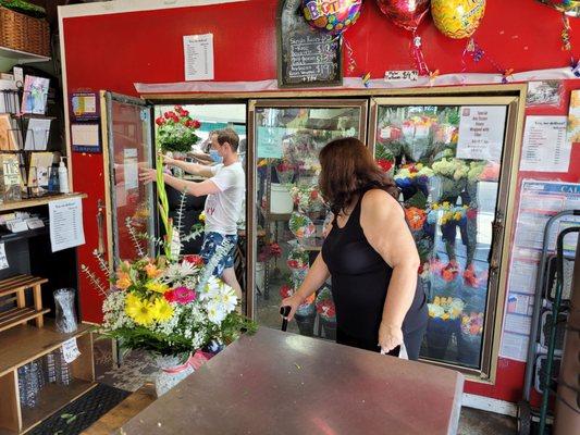 Getting personalized help at the Fresh Cut Flowers kiosk.